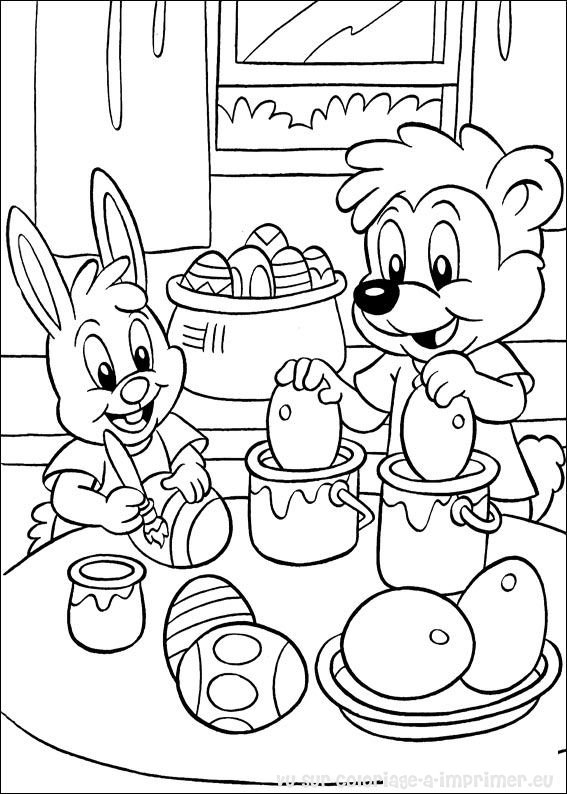 Coloriage de Pâques avec un lapin et des œufs colorés dans un jardin