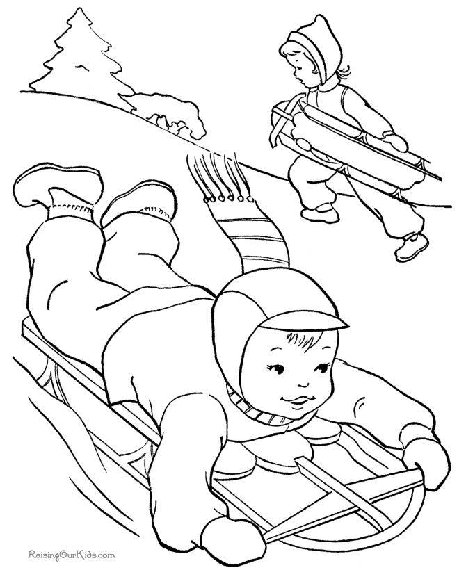 Un enfant joue dans la neige tout en faisant un bonhomme de neige Un enfant joue dans la neige tout en faisant un bonhomme de neige