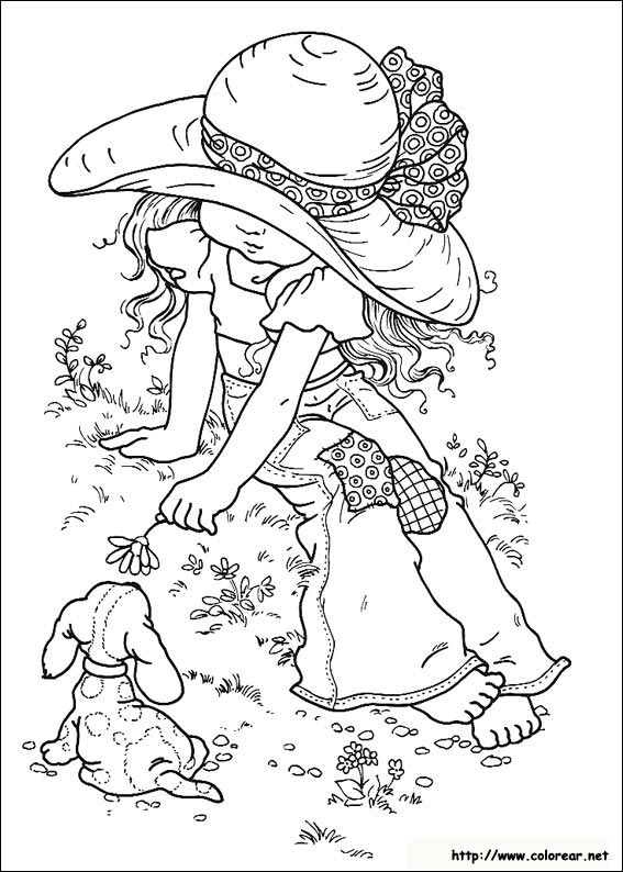 Une jeune fille et son chat dans un jardin fleuri